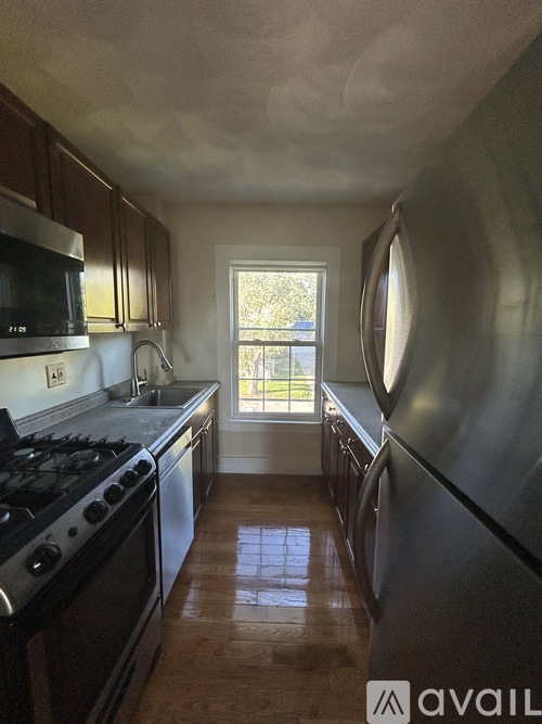 A kitchen with a stove, microwave, and oven.