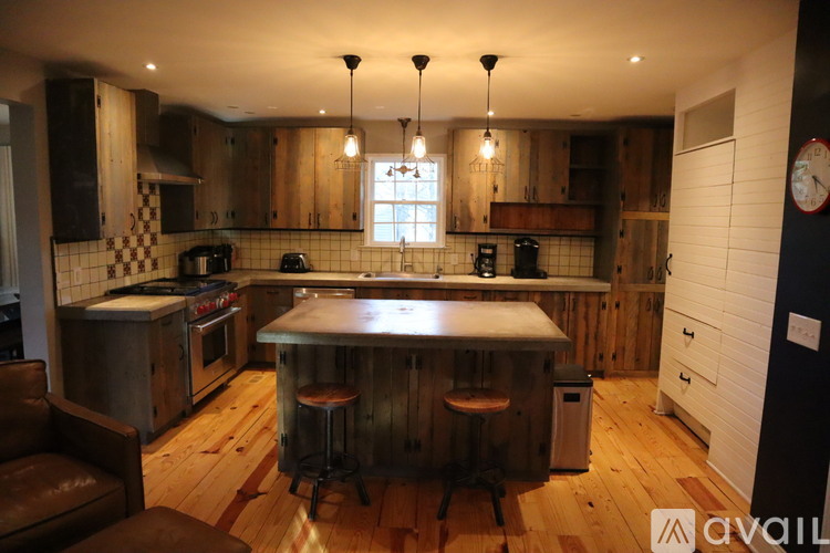 A kitchen with wooden cabinets and a checkered tile backsplash.