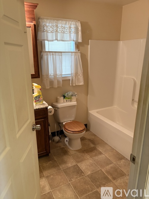 A bathroom with a toilet, tub, and sink.