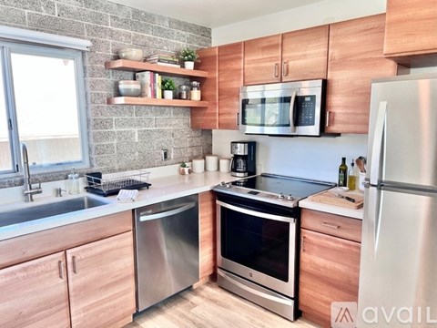 A kitchen with wooden cabinets and stainless steel appliances.