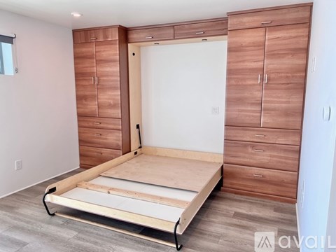 A bedroom with a bed, wardrobe and a window.