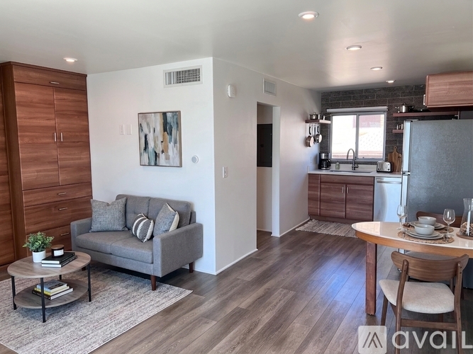 A living room with a grey couch and a coffee table.