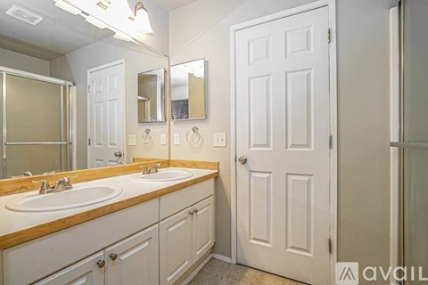 A room with a ceiling fan and two windows.