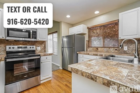 A kitchen with a stove, refrigerator, and cabinets is on the market.