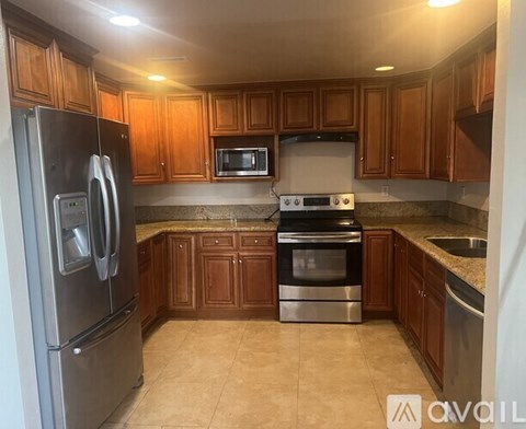 A kitchen with wooden cabinets and stainless steel appliances.