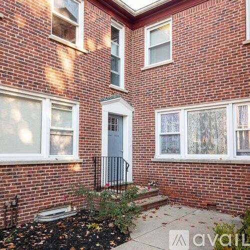 A brick house with a white door and windows.