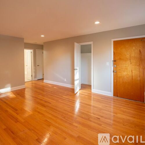 A room with wooden floors and white walls.