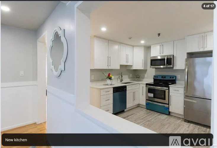 A kitchen with white cabinets and stainless steel appliances.