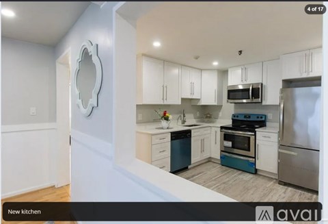 A kitchen with white cabinets and stainless steel appliances.