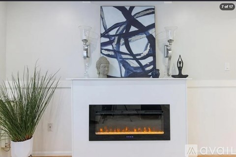 A modern fireplace with a blue abstract painting above it.