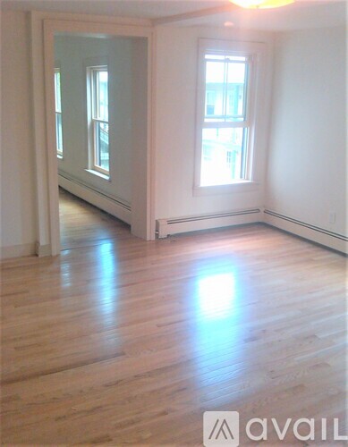A room with wooden floors and a window.