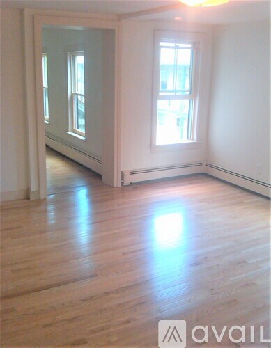 A room with wooden floors and a window.