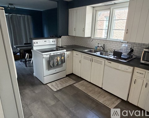 A kitchen with a white oven and cabinets.