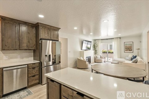 A kitchen with wooden cabinets and a white countertop.