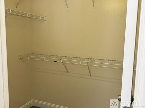 Empty white shelves in a room.