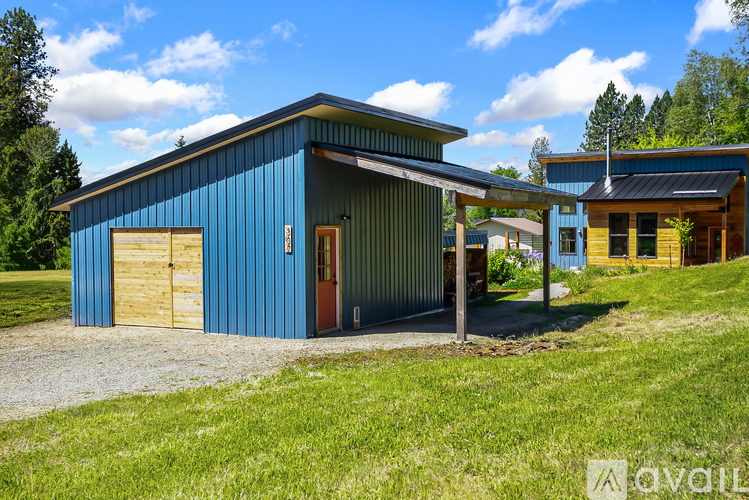 A blue building with a brown door and windows.