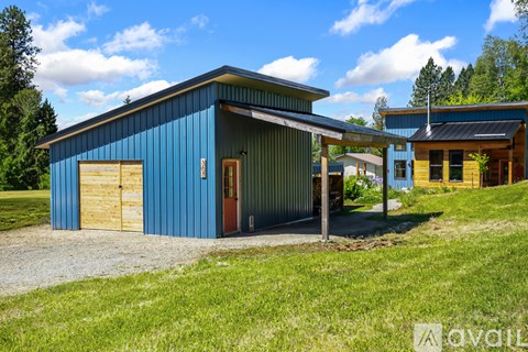 A blue building with a brown door and windows.