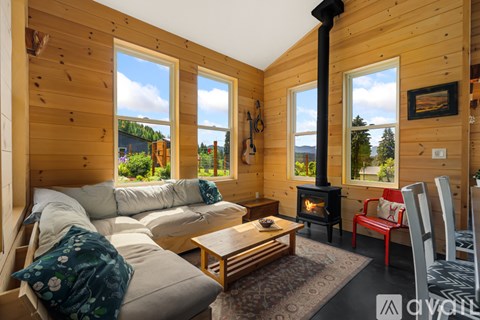 A cozy living room with a wood stove and a large window.