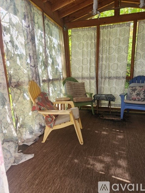 A room with a wooden chair and a blue bed.