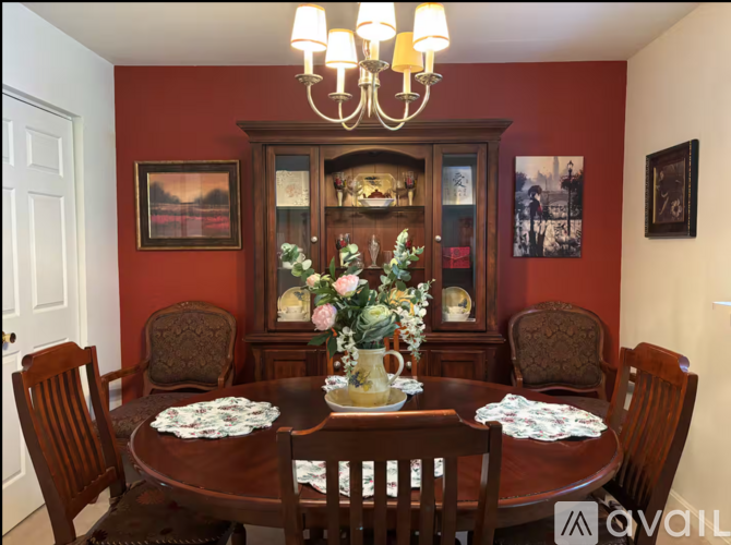 A dining room with a wooden table set for six.