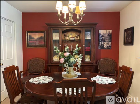 A dining room with a wooden table set for six.