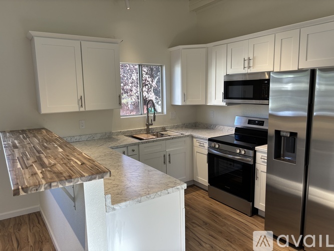 A kitchen with white cabinets and stainless steel appliances.