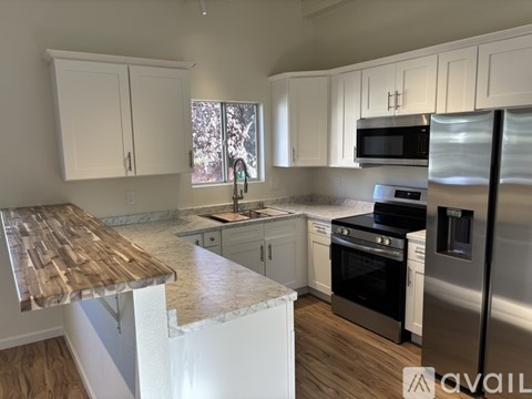 A kitchen with white cabinets and stainless steel appliances.