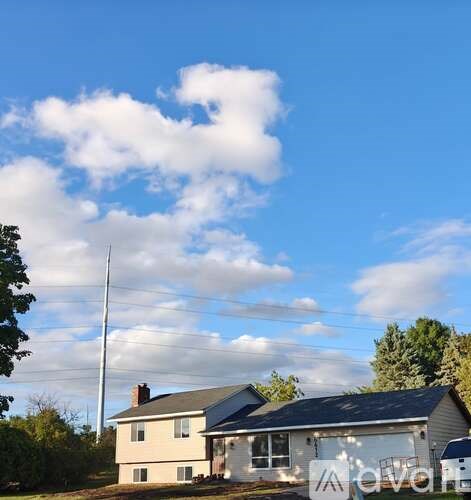 A house with a sign that says "Ava" in front of it.