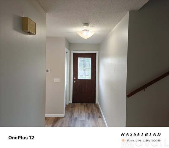 A hallway with a door and a window.