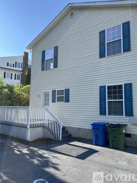 A house with a white fence and blue windows.