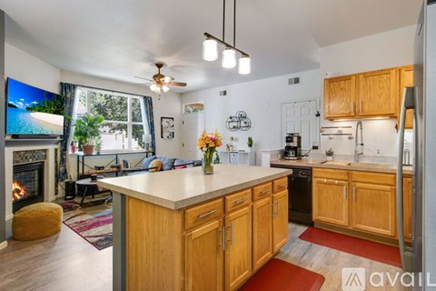 A kitchen with wooden cabinets and a white countertop.