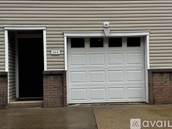 A white garage door with the number 868 on it.