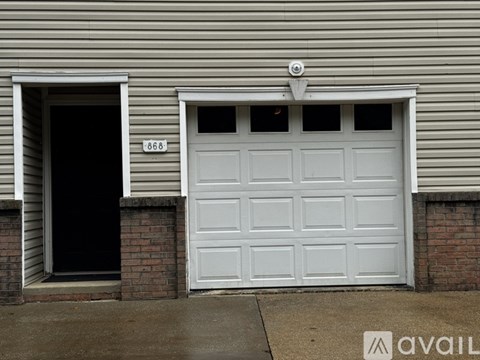 A white garage door with the number 868 on it.