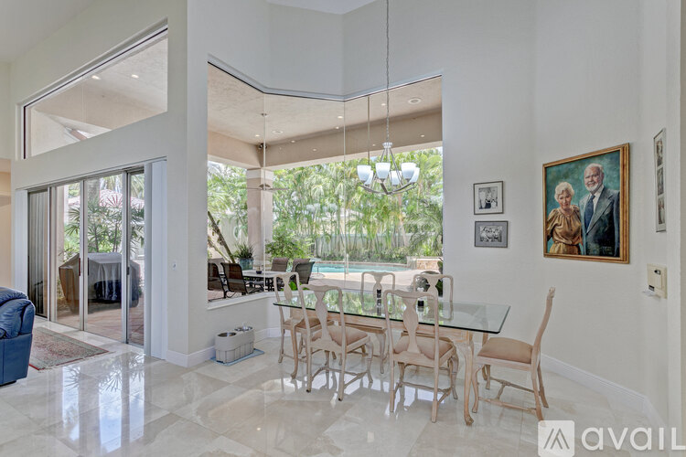 A dining room with a glass table and chairs.
