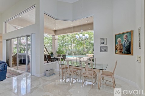 A dining room with a glass table and chairs.