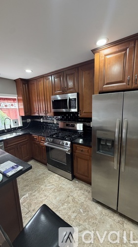 A kitchen with wooden cabinets and stainless steel appliances.