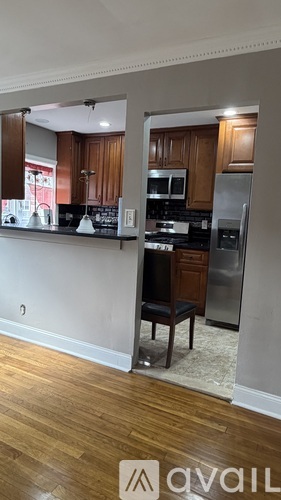 A kitchen with wooden cabinets and a black countertop.