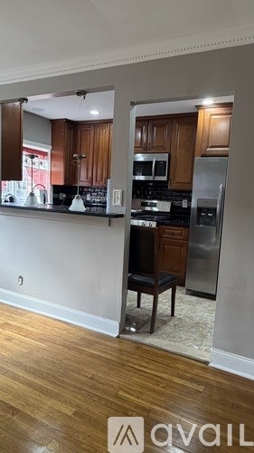 A kitchen with wooden cabinets and a black countertop.