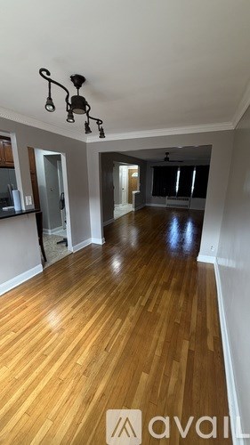 A room with wooden floors and a chandelier.