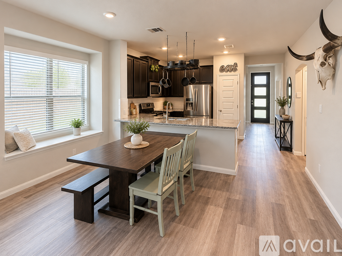 A modern kitchen with a wooden table and chairs.