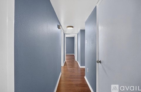 A long hallway with doors on both sides.