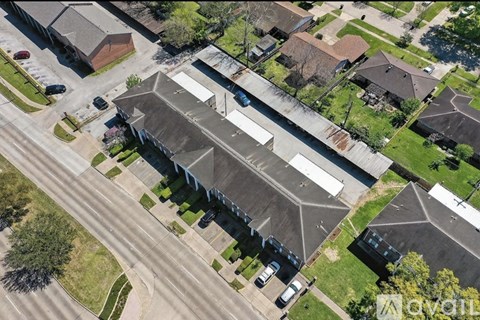 An aerial view of a neighborhood with a large building in the center.