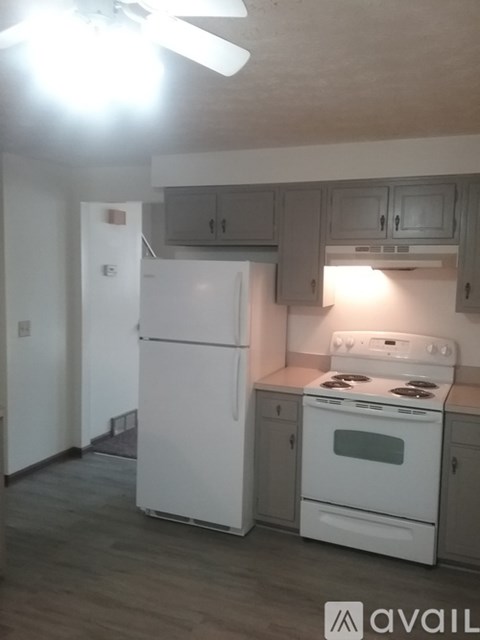 A kitchen with a white refrigerator and stove.