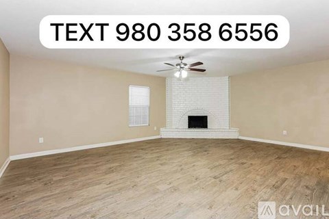 A room with a fireplace and a ceiling fan.