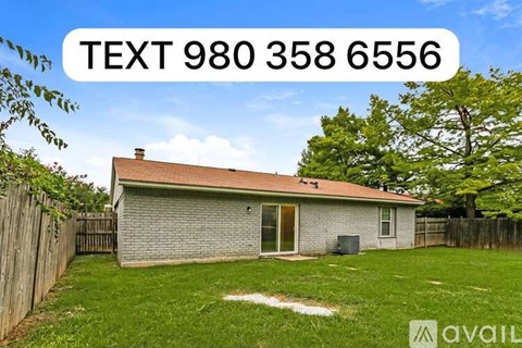 A house with a fence and trees in the background has a text overlay that reads "TEXT 980 358 6556".