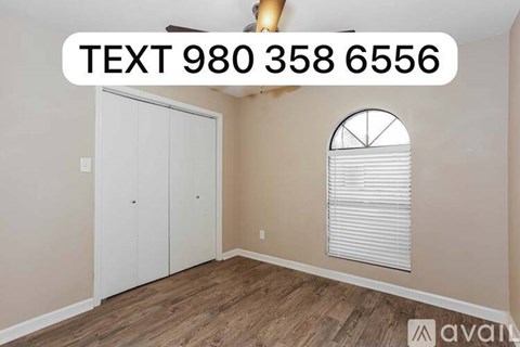 A room with a white door and a window with blinds is available for rent.