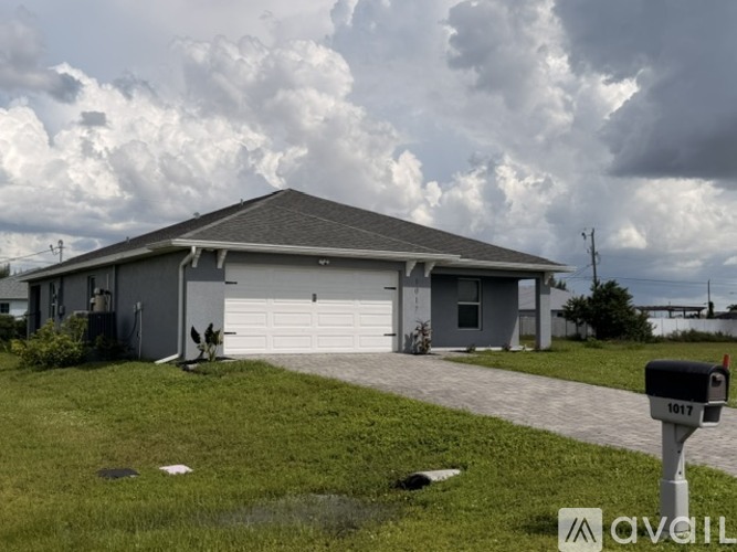 A house with a grey roof and a white garage door is shown.