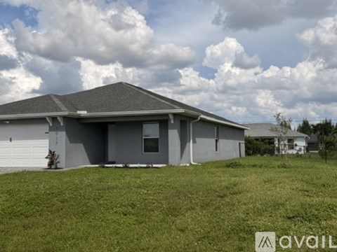 A house with a grey roof and a sign that says "AVAILABLE" in front of it.
