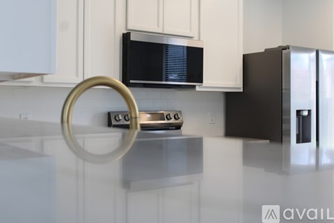 A kitchen with a microwave, toaster, and refrigerator.