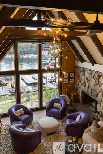 A living room with a view of the water and a chandelier.